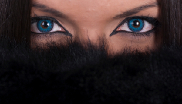 Beautiful woman with blue contact lenses covering her face