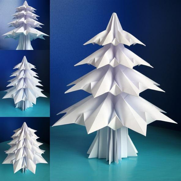 origami-zu-weihnachten-weißer-schöner-tannenbaum - hintergrund in blauer farbe