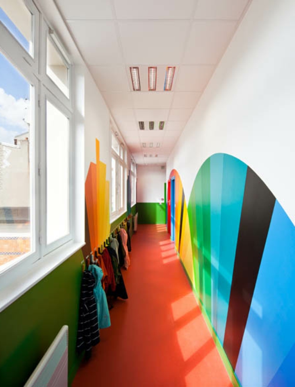 kindergarten-mit-regenbogen-motiven-sehr-interessanter-flur-mit-bunter-wandgestaltung-großen-fenstern-und-kleiderehändern