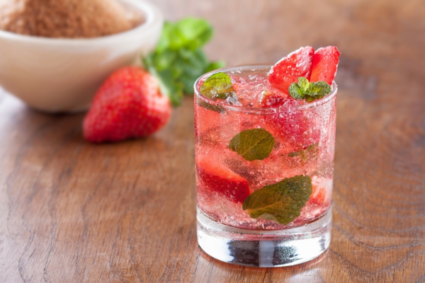 Strawberry mojito served with lime and crushed ice