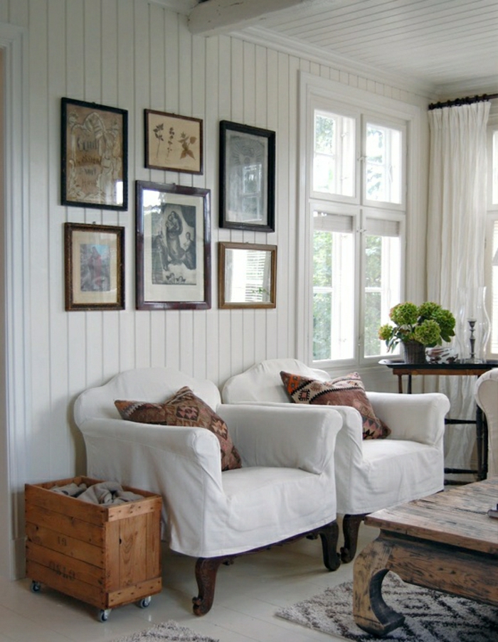 Wohnzimmer-rustikaler-Stil-Sessel-Kasten-Tisch-Massivholz-Wandbilder