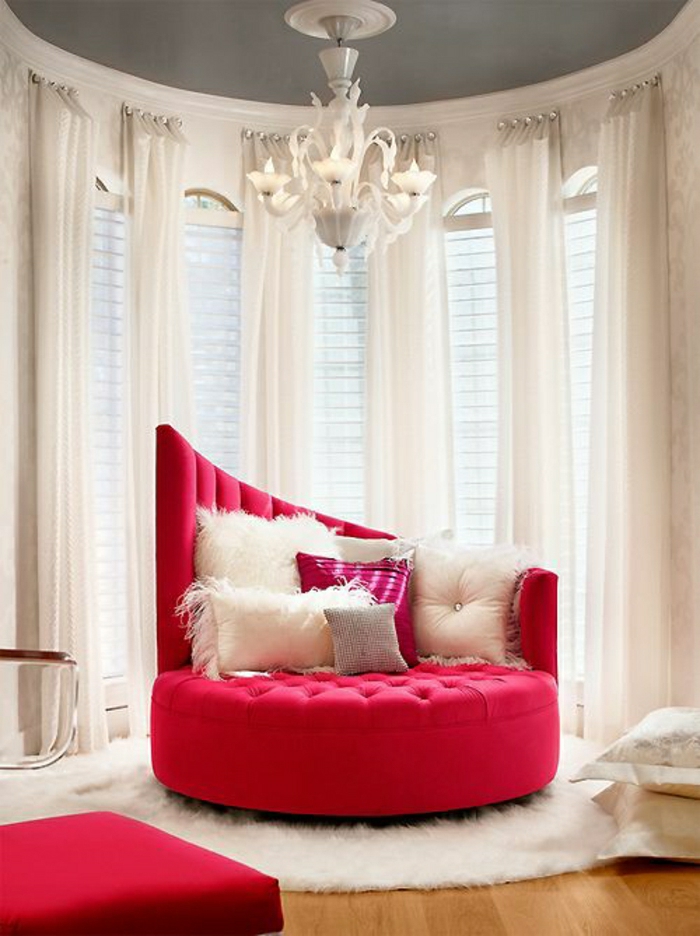 Luxus-Gestaltung-roter-Sessel-schick-Kissen-flaumiger-Teppich-weiße-Gardinen-Kronleuchter-extravagant