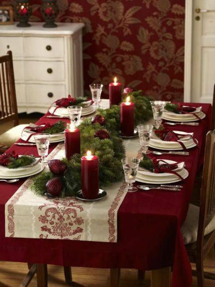 stilvolle-weinrote-Tischdeko-zu-Weihnachten-Zapfen-Tannenzweige-Kerzen
