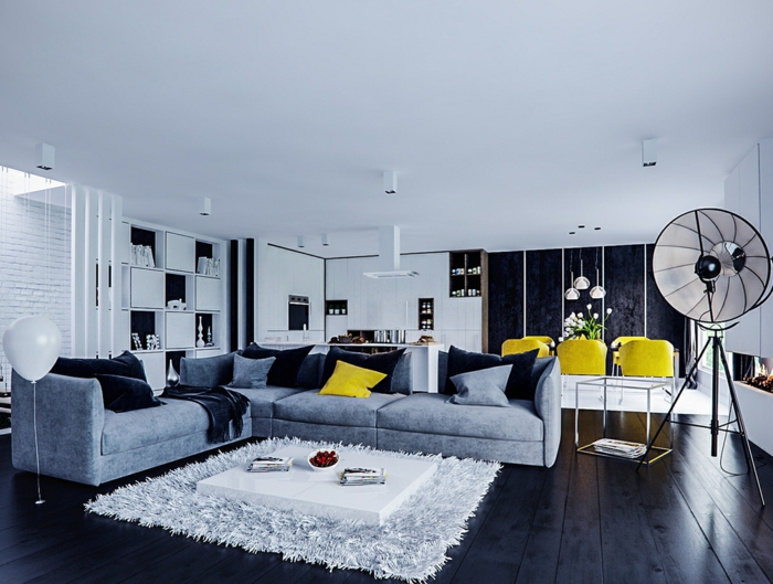 künstlerisches-Wohnzimmer-Interieur-Atelier-gelbe-Esstisch-Stühle-flaumiger-weißer-Teppich