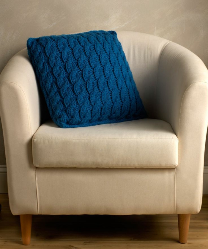 schöner-Sessel-beige-Farbe-Kissen-stricken-Modell-in-Blau-stricken-zopfmuster