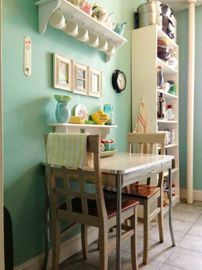 kokettes-Küchen-Interieur-Wand-in-Minze-Farbe-kleiner-quadratischer-Tisch-vintage-Stühle