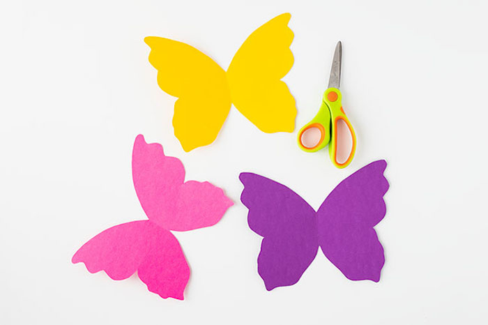 Schmetterlinge basteln mit Kindern, Flügel aus Karton schneiden, an Klorollen kleben 