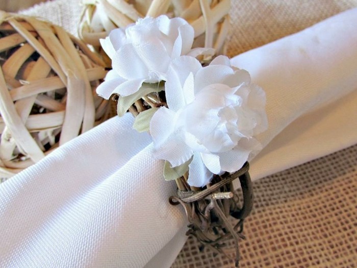 Festliche-Serviettenformen-mit-weißen-Blumen