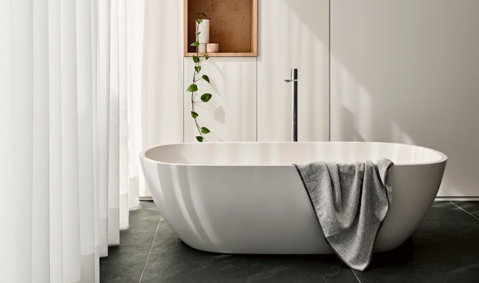 designer badezimmer einrichtung, freistehende badewanne in minimalsitischem stil, schwarze bodenfliesen, weiße gardinen
