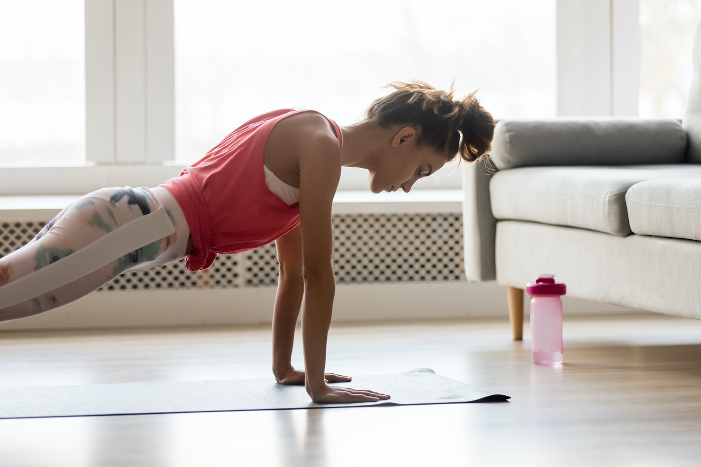 sportive girl doing push press ups exercise at home