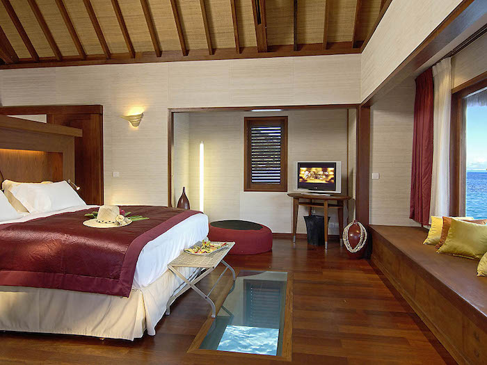 hotelzimmer luxus in rot und weiß schönes zimmer mit blick nach unten im wasser fernsehwand großes boxspringbett