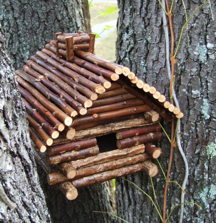 kleines Vogelhaus aus Holzstäcken mit Schornstein