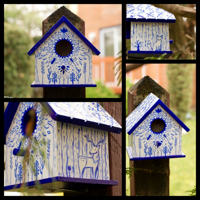 weißes Vogelhaus mit Zeichnungen in blauer Farbe 