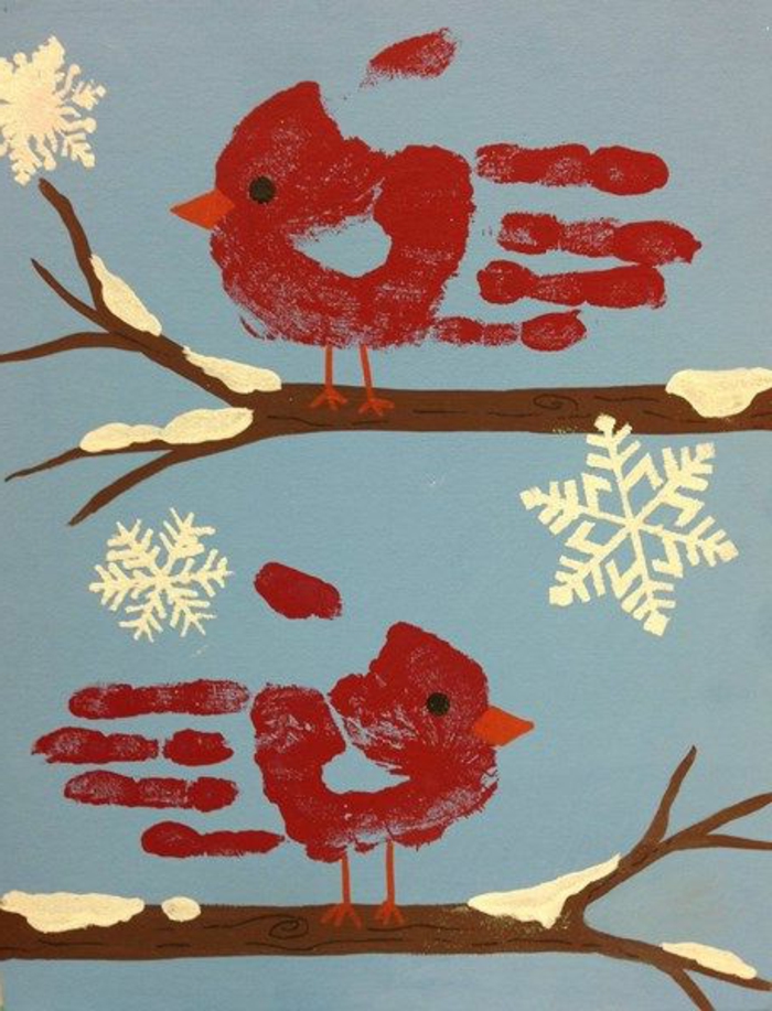 zwei rote vögel und scghneeflocken -handabdruck bilder 