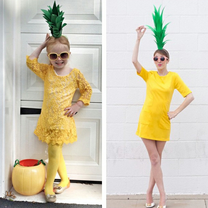 ein kleines Mädchen und eine Frau wie Ananas gekleidet