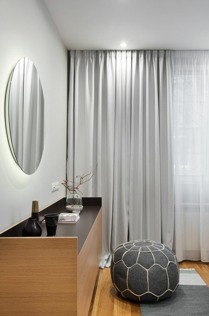moderne vorhänge in silbern, schrank aus holz, runder spiegel