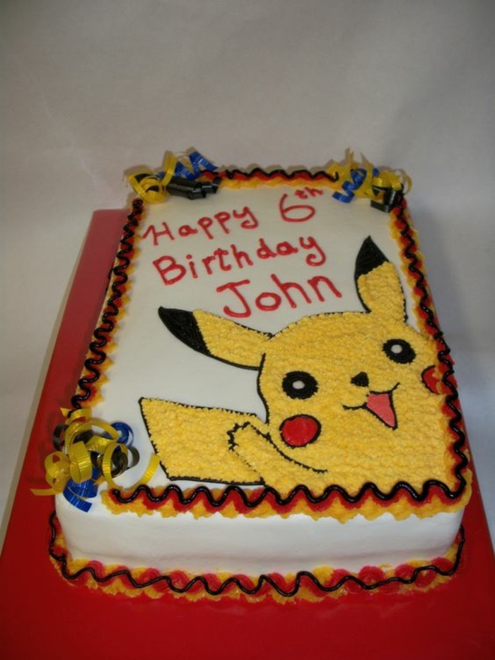 eine pokemon torte mit einem lächelnden pokemon wesen - ein gelbes pikachu mit roten backen 