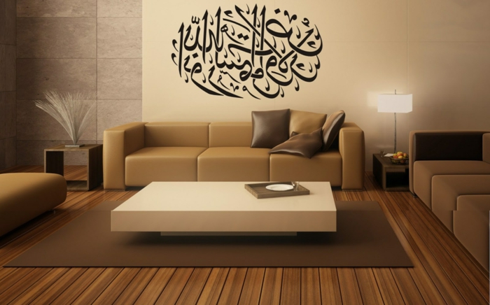 orient möbel beiges sofa braune glänzende kissen tisch in weißer farbe wanddeko aufschrift auf arabisch arabische kunst