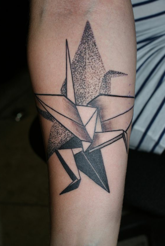 ganz tolle idee für einen schönen origami tattoo - eine schwarze tätowierung auf der hand mit verschiedenen origami motiven 