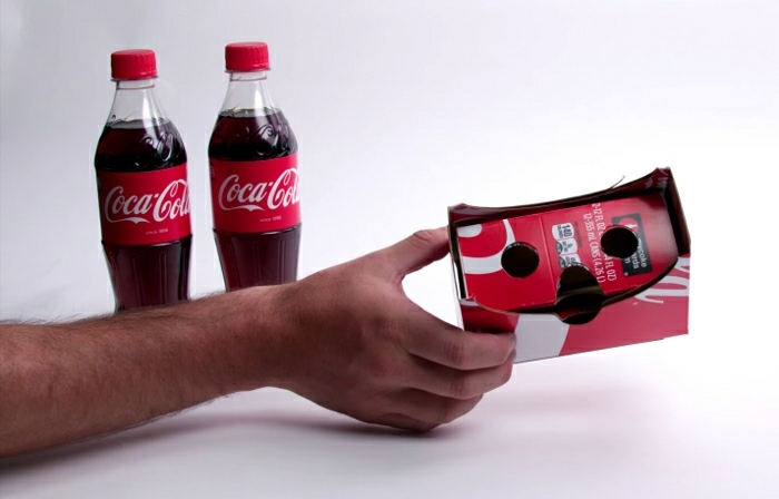 hier ist eine hand mit einer roten vr brille aus coca-cola flaschen - zwei rote coca-cola flaschen 