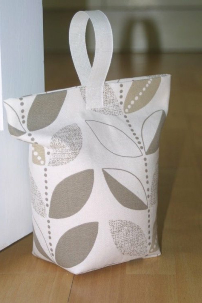 Türstopper Sack in weißer Farbe mit Blättern in grauer Farbe wie eine Tüte
