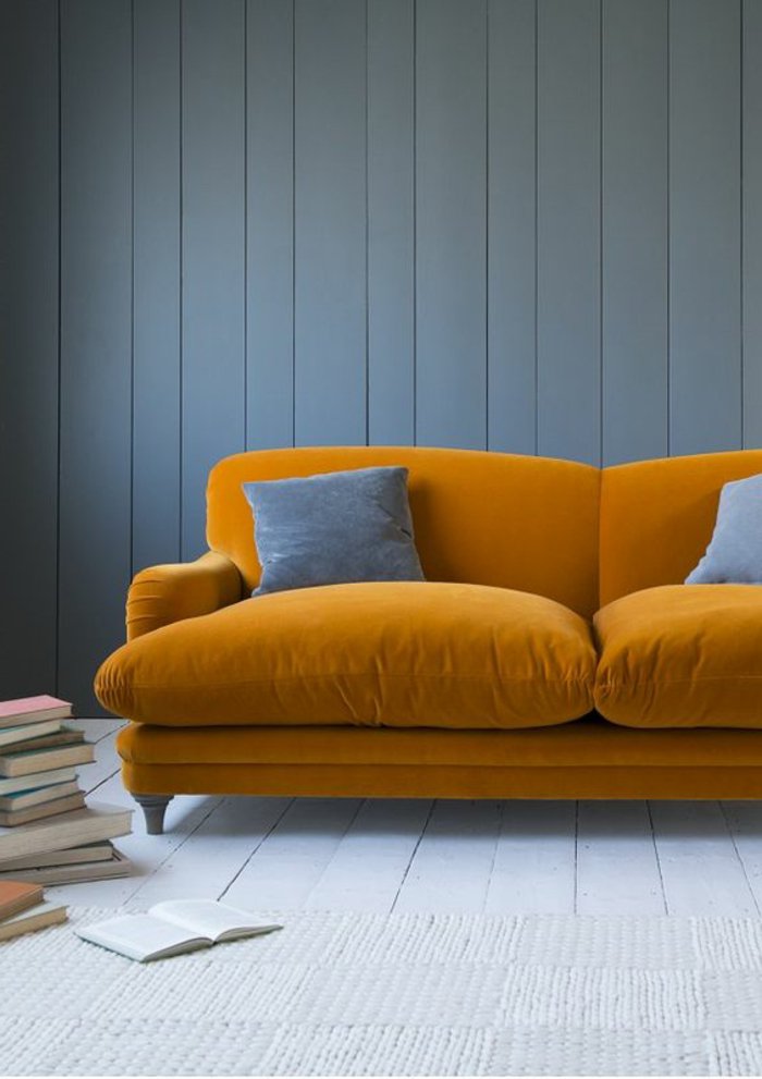 gelbes Sofa mit grauen Kissen, graue Bodenbeläge und graue Wände - graues Zimmer