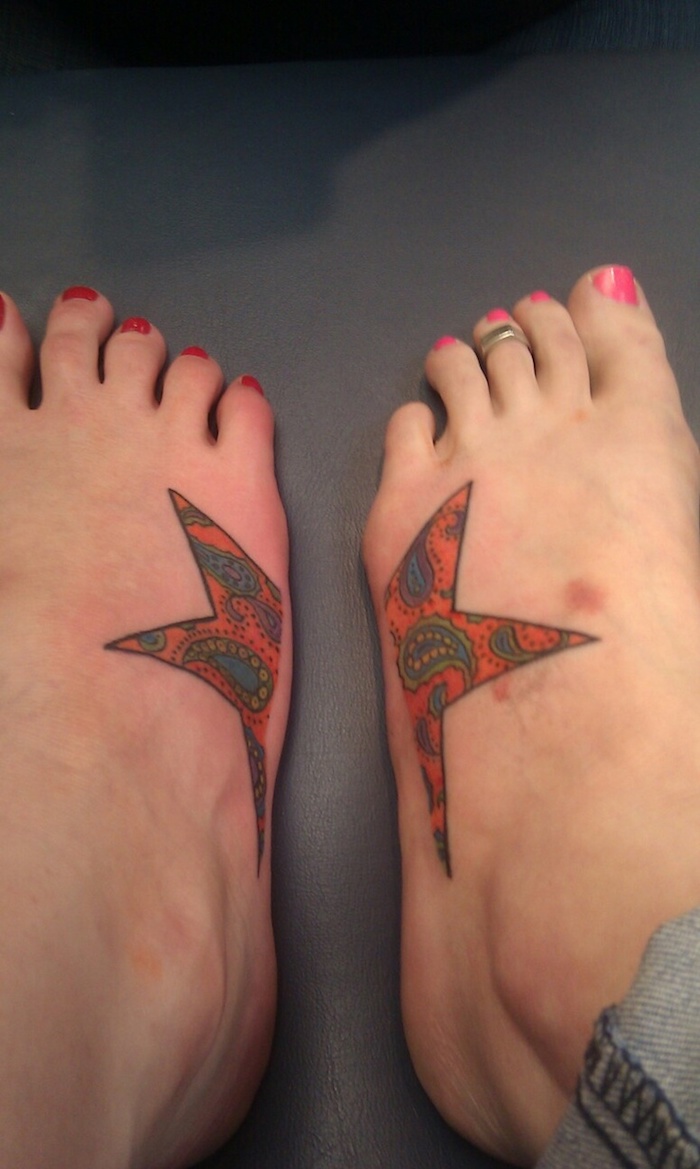ein Stern in roter Farbe in zwei Teilen an den Füßen von zwei Schwestern - Symbol für Schwestern