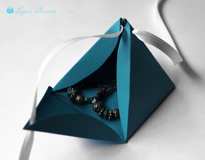 Pyramide-Geschenkverpackung für Ohrringe in dunkelblau mit einer silbernen Schleife