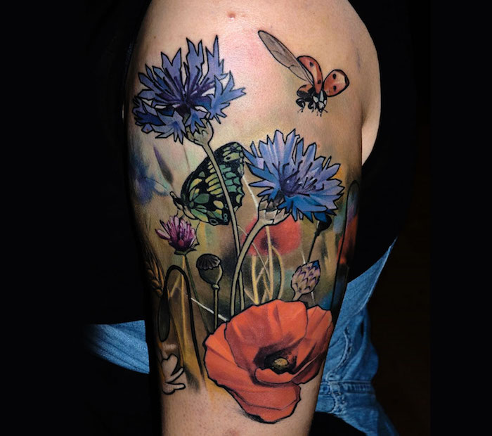 Tattoo oberarm blumen Marsha Ambrosius