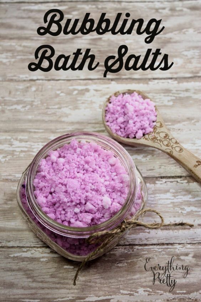Badesalz mit Lavendel, kleines Einmachglas mit Faden verziert, Kochlöffel daneben, Hausmittel für Erholung und Entspannung