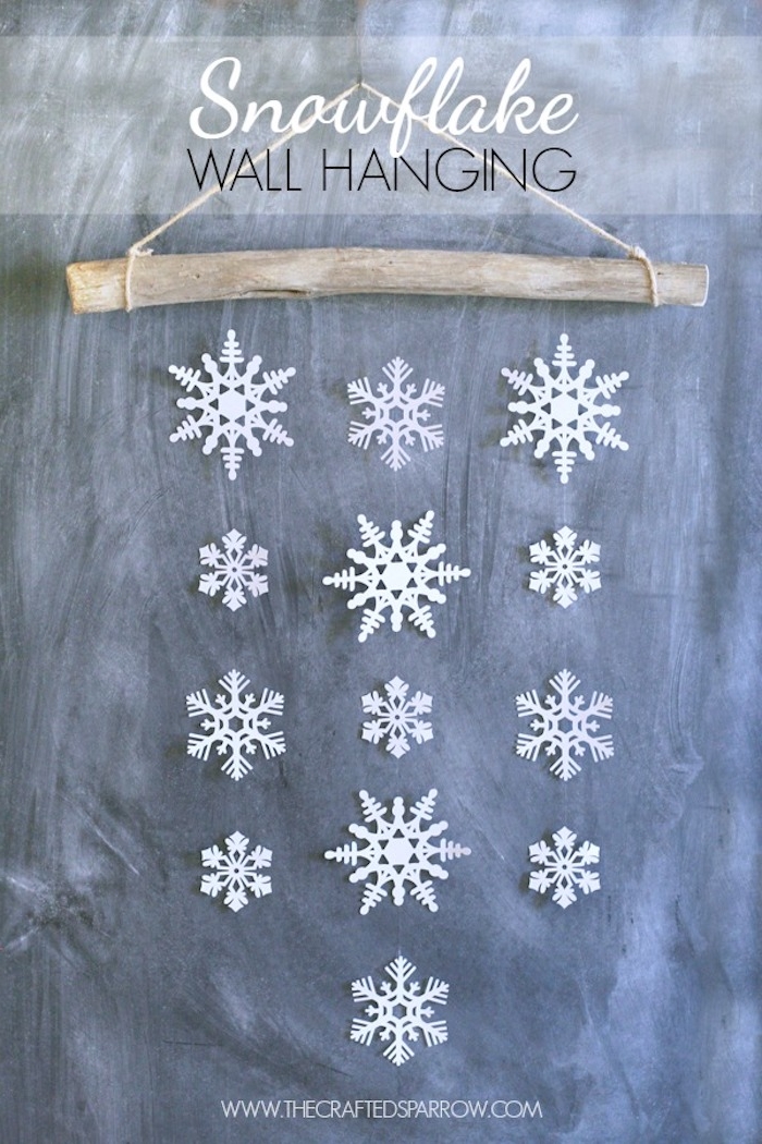 Basteln Winter - eine Wand aus weißen Schneeflocken von einem Stock hängend