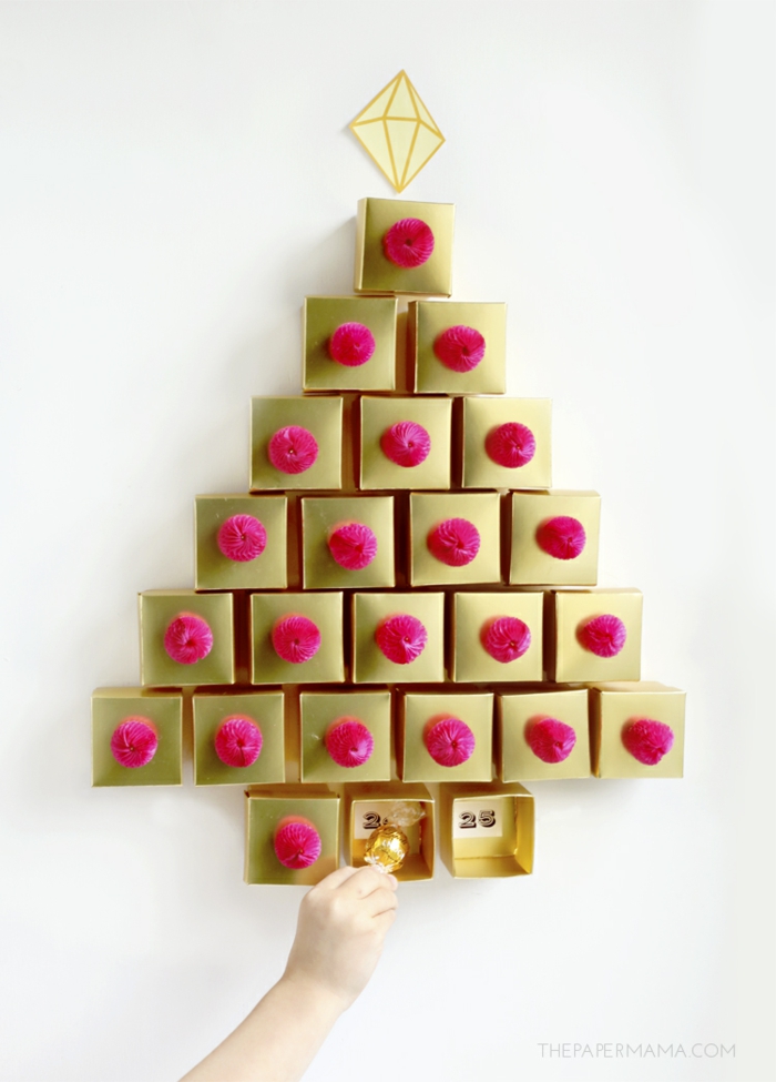 Adventskalender aus kleinen goldenen Schachteln voll mit Schokoladen Kugeln, schöner Weihnachtsbaum