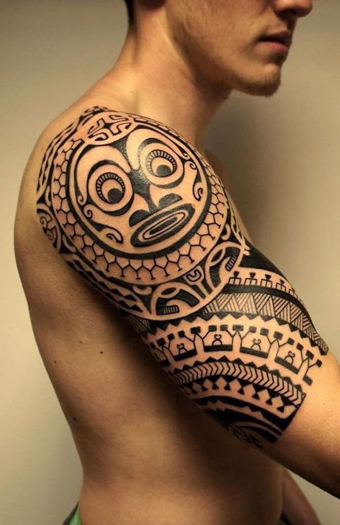 maori tattoo bedeutung - ein mann mit einer hand mit einem großen schwarzen maorie tattoo mit einem wesen mit einer schwarzen nase und zwei großen schwarzen augen