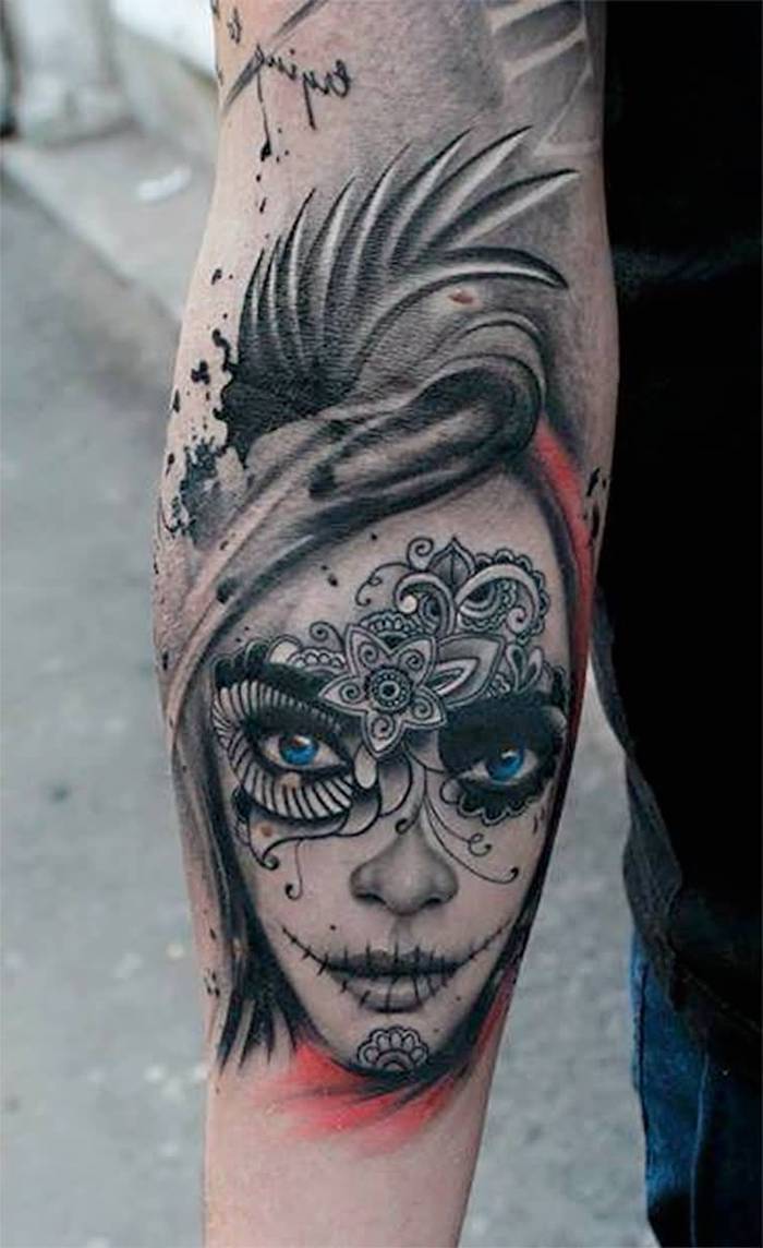 hand mit einem tattoo mit einer jungen frau mit blauen augen und mit weißen blumen und schwarzen lippen - la catrina tätowierung