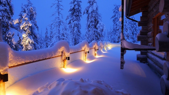 ein haus und eine terrasse mit schnee - ein wald mit vielen großen bäumen un der nacht - schöne winterbilder