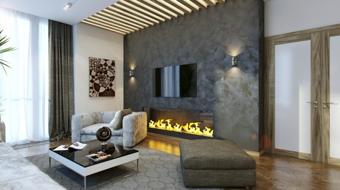graue Natursteinwand, Sessel und Hocker, Teppich mit geometrischem Muster
