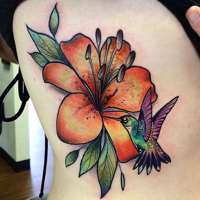 kolibri tattoo an der körperseite, kolibri und große orange blume