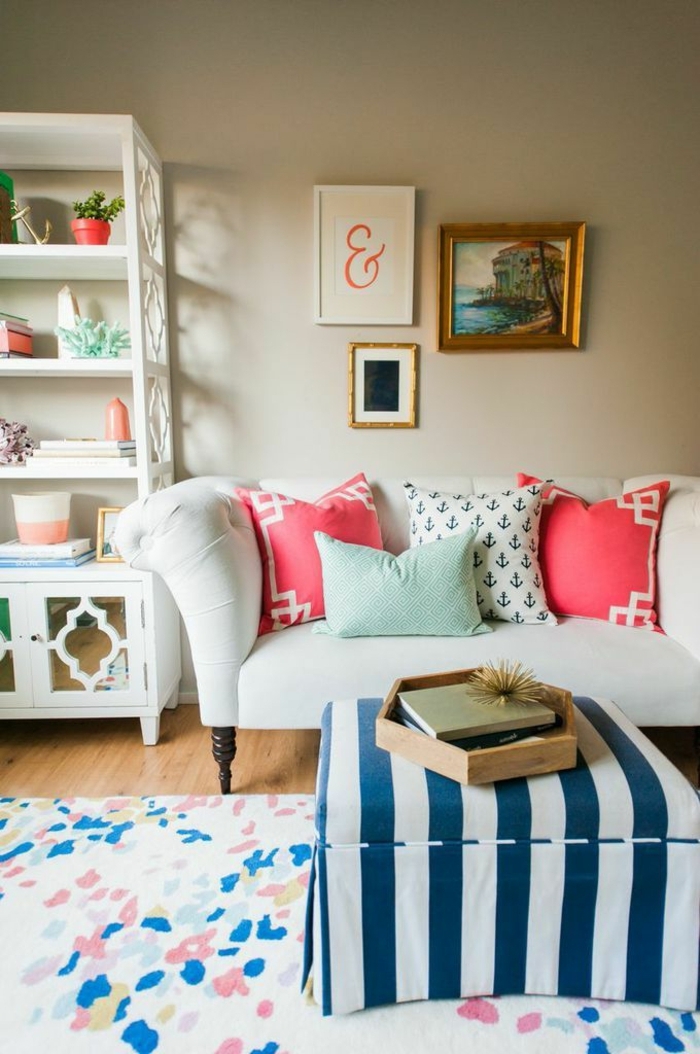 ein kompaktes Zimmer, kleine Wohnung einrichten, ein bunter Teppich, gestreifte Decke von Tisch, weiße Couch mit bunten Kissen