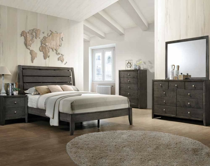 ein Schlafzimmer grau, braune Weltkarte als Wandtattoo, runder Teppich