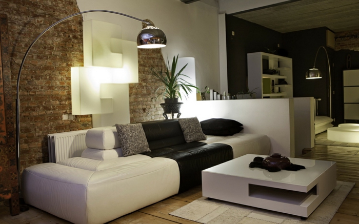schwarz weißes Sofa, ein kleiner weißer Couchtisch, eine braune und weiße Wand, kleine Räume einrichten