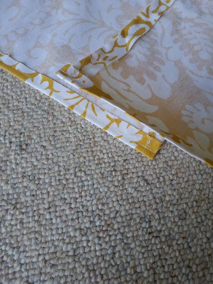 ein teppich und ein gelber stoff mit vielen kleinen und großen weißen blumen mit weißen blättern, ein kinderzelt tipi nähen, bastelanleitung 