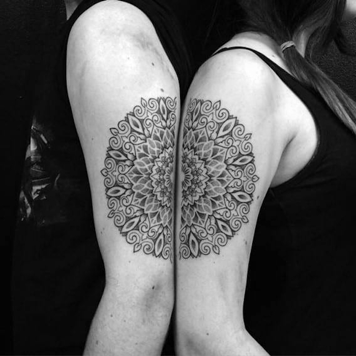 ein mann und eine frau mit händen mit zwei großen schwarzen tattoos, die sich ergänden, mandala tattoos mit schwarzen mandala blumen