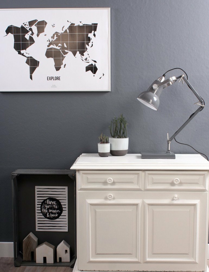 graue Wände, eine graue Lampe, eine Landkarte, weißer Schreibtisch