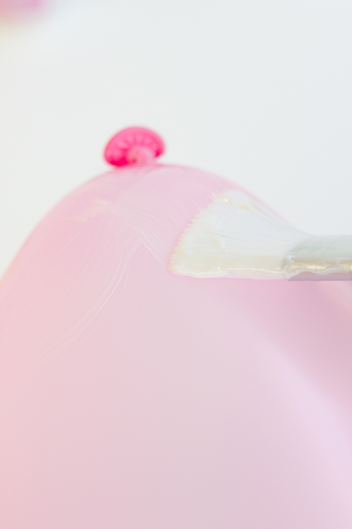 Rosafarbenen Ballon mit Bastelkleber bestreichen, DIY Projet erster Schritt, Ballons mit Glitter dekorieren