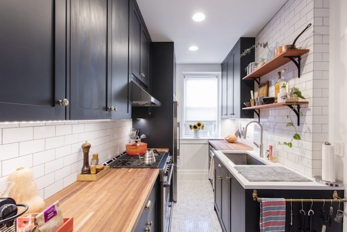 einrichtungsstil modern, kleine küchen einrichten, schwarze schränke, weiße steinwand