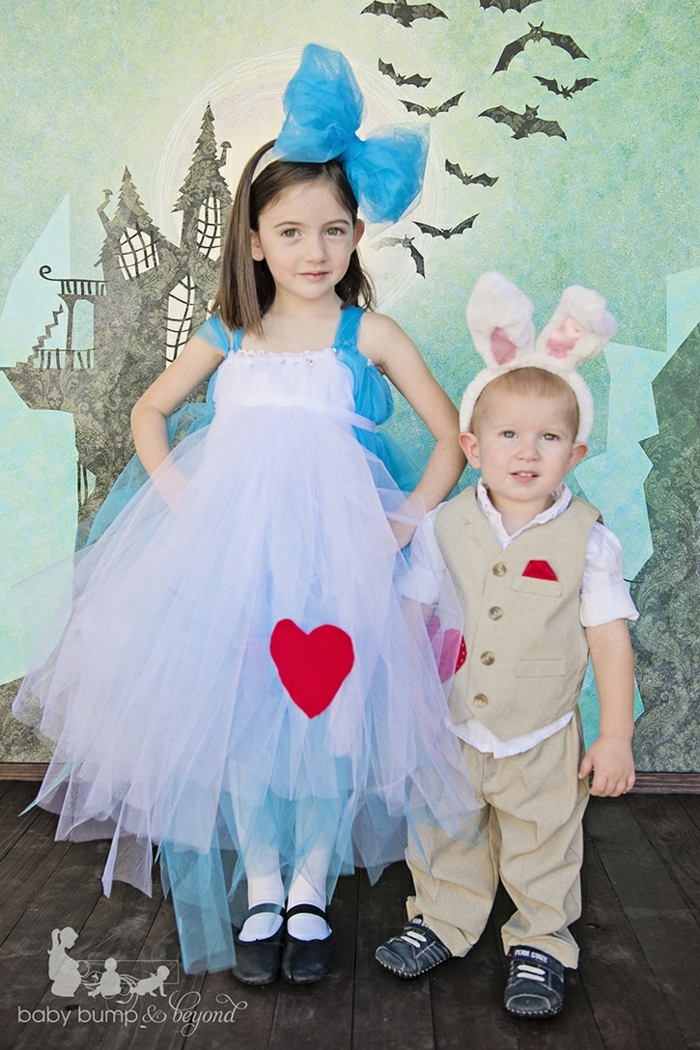 zwei Kinder mit Kostümen aus dem Buch Alice in Wunderland, das Mädchen ist Alice, der Junge ist der Hase