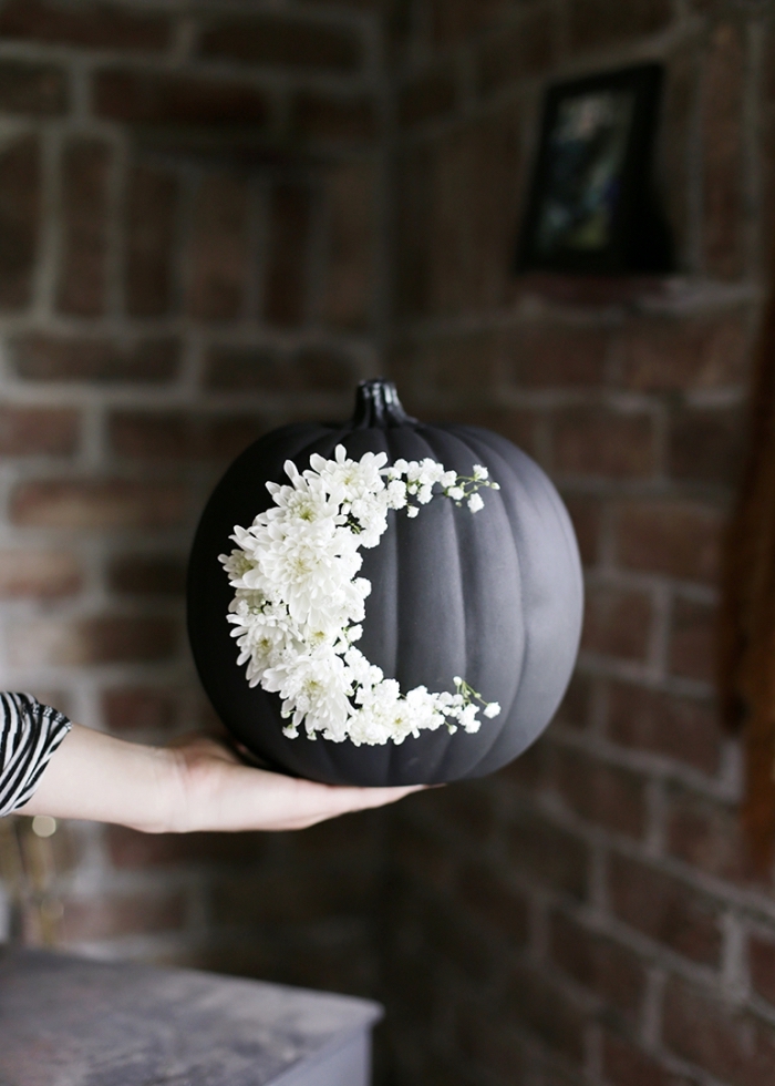 halloween bastelideen, diy herbstdeko, schwarzer kürbis dekoriert mit kleinen weißen blümchen