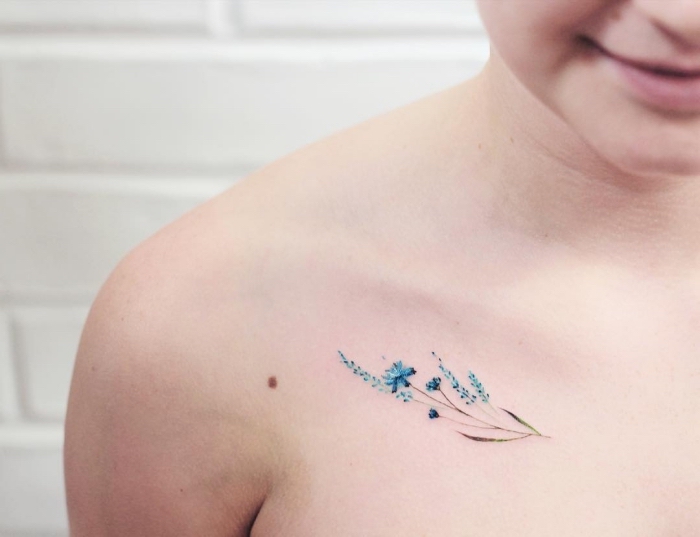 tattoo unterarm, bunte blumen in blau gestaltet, tattoo amm schulter