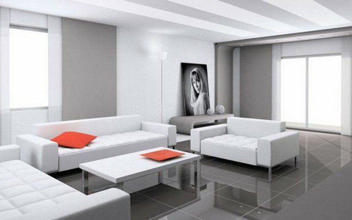 Wohnzimmer in Grau Weiß, weiße Wohnzimmermöbel, grauer Boden, rote Kissen, ein Wandbild
