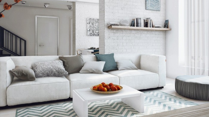 ein Regal mit Büchern, ein weiße Couch mit bunten Kissen, ein weißer Tisch, bunter Teppich, Wohnzimmer Ideen Weiß Grau